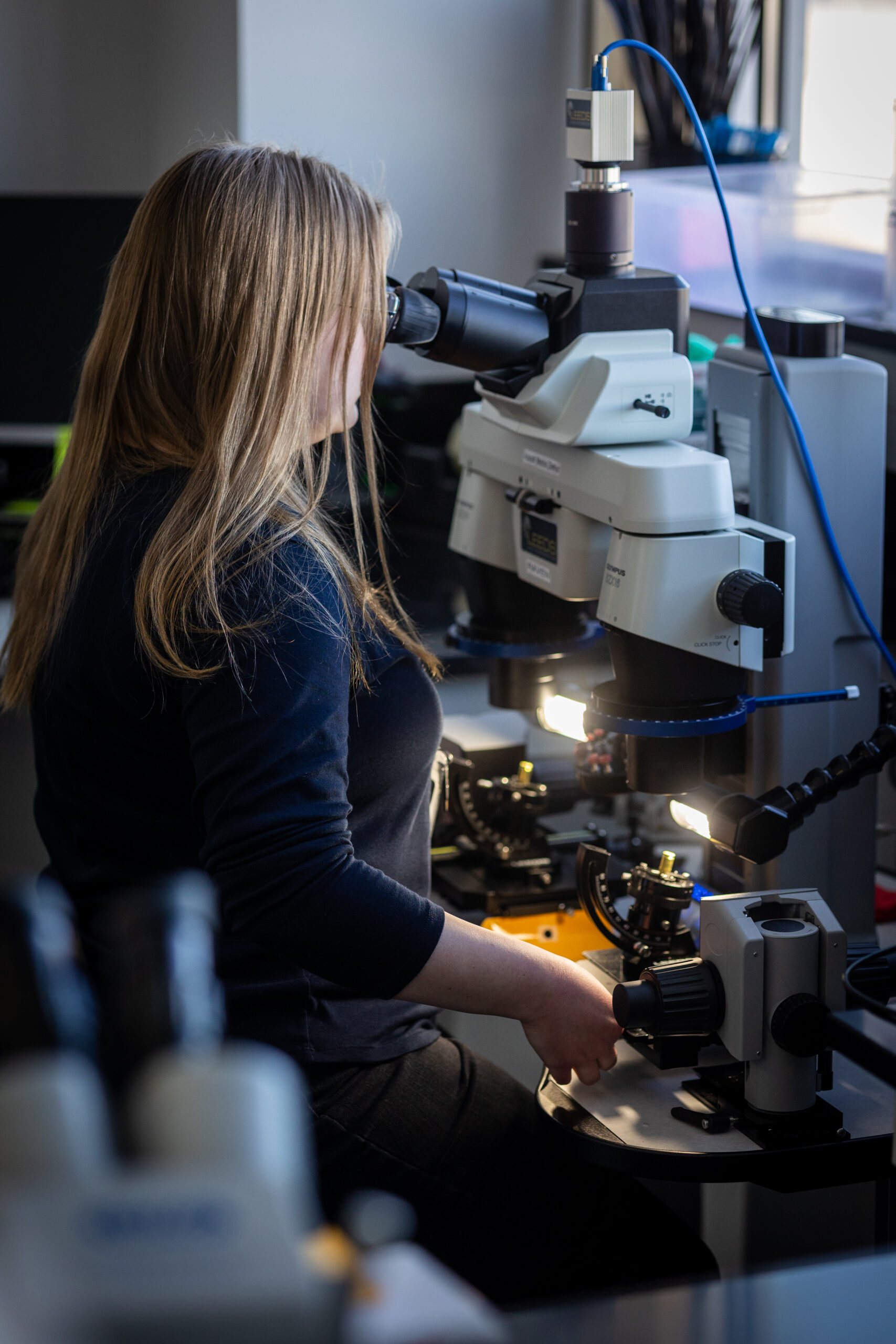 Scientist at a comparison microscope