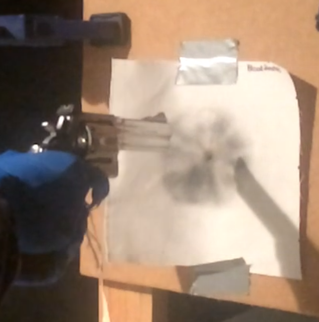 A gun is fired at a paper as part of a distance determination