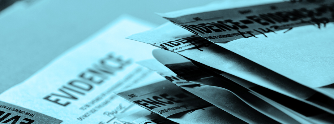 Envelopes marked with tape saying "evidence" are stacked