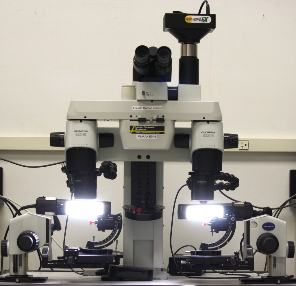 A comparison microscope sits on the counter