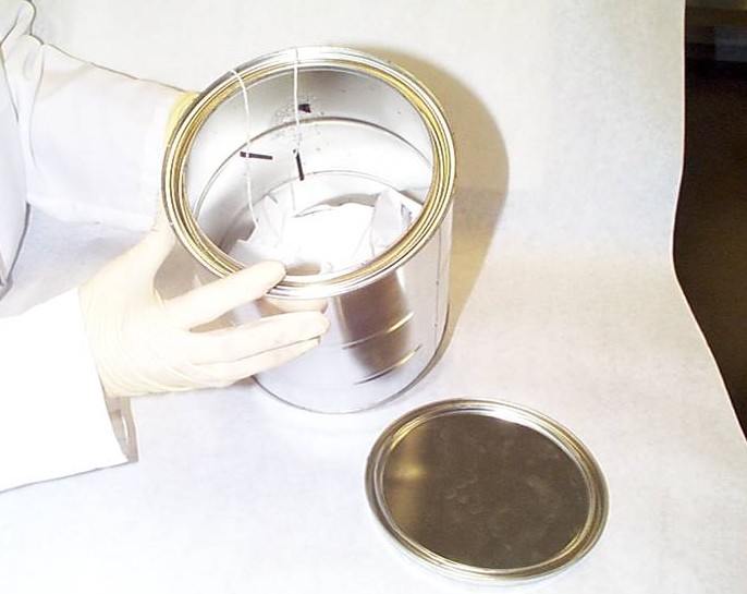 A metal can has fire debris cloths in it